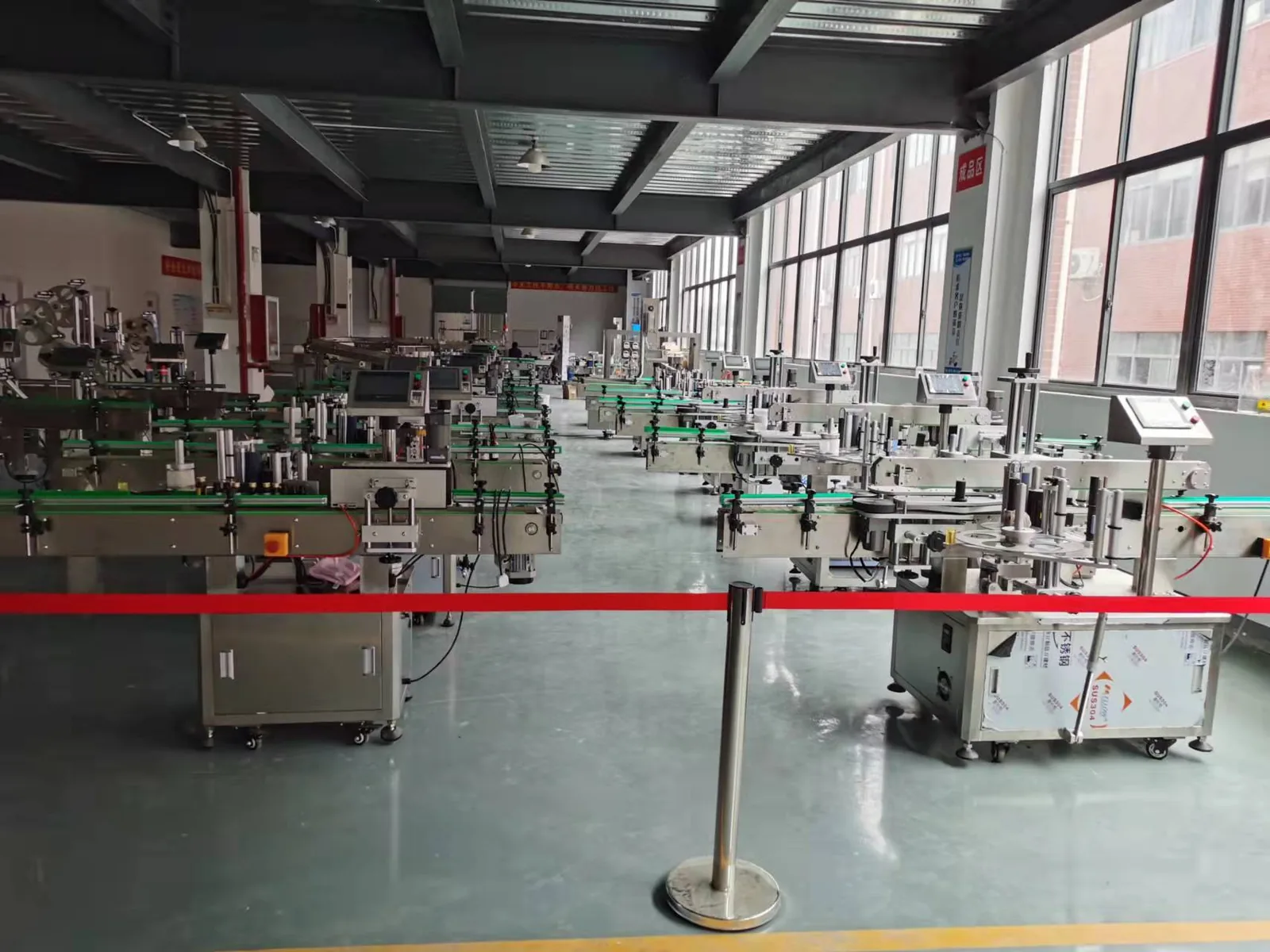 Company-owned photo of labeling machine factory labeling machine production floor hero-01, catalog view 024.