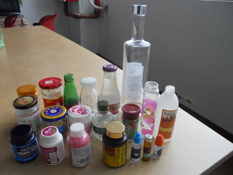Company-owned photo of positioned round bottle labeling sample results, catalog view 005.