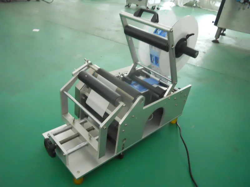 Company-owned photo of semi automatic round bottle labeling machine company view, catalog view 050.
